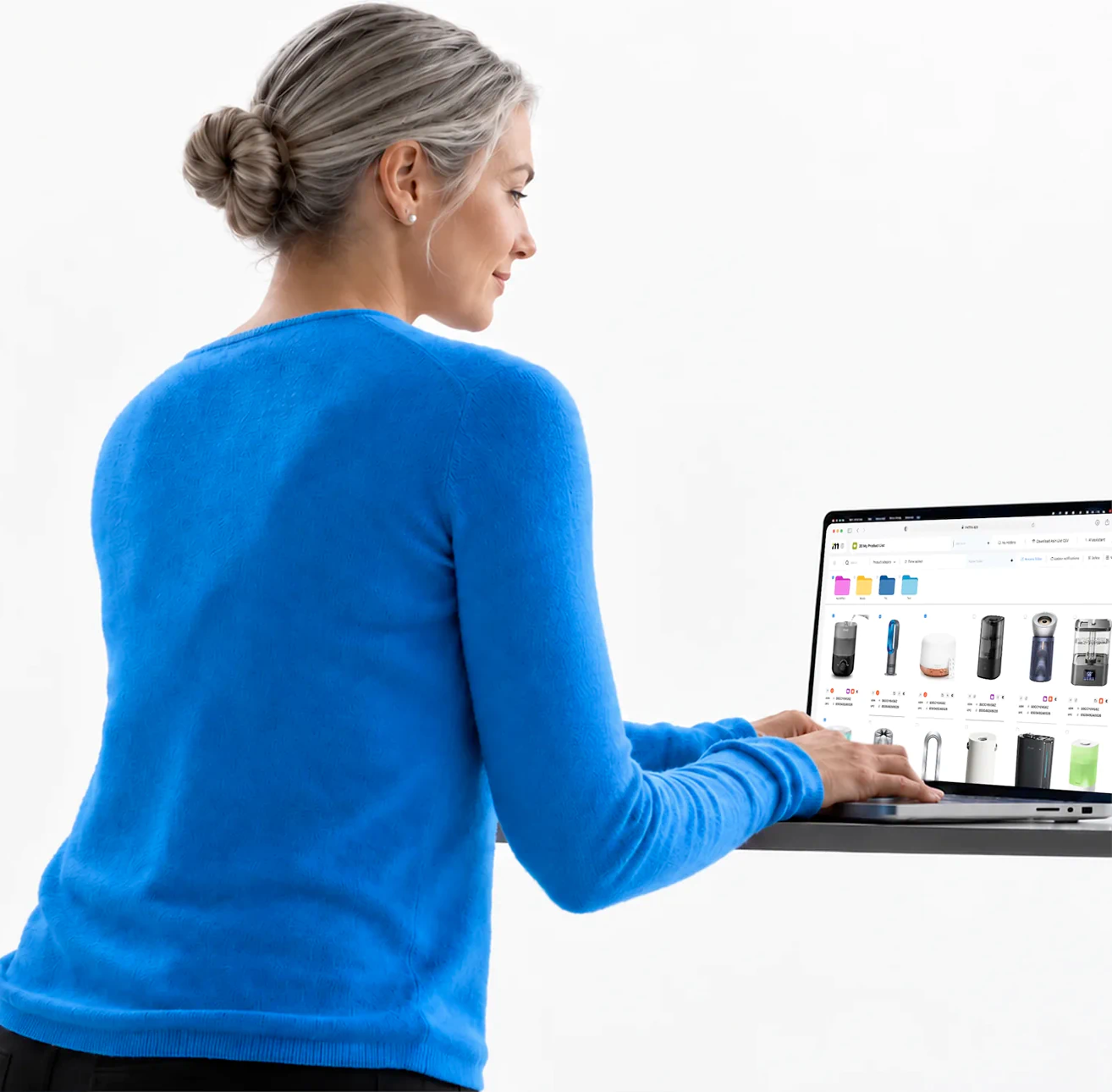 A seller at a standing desk reviewing saved Amazon products